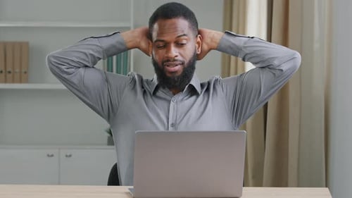 Young Office Worker Working Overtime Performing Urgent Assignment Preparing Report Typing on Laptop