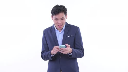 Excited Young Businessman Celebrates Good News on Phone