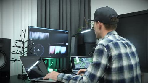 Freelancer video editor works at laptop computer.