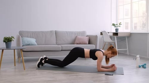 Woman Doing Elbow Plank Exercise at Home