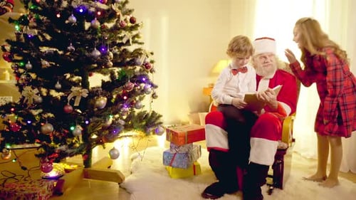 Santa Claus Reads Story to Children at Christmas