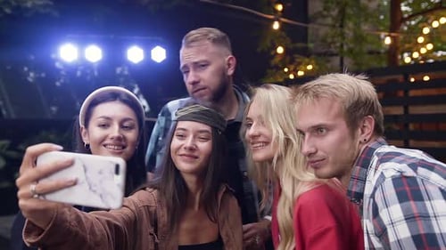 Friends Taking Selfie at Outdoor Evening Gathering
