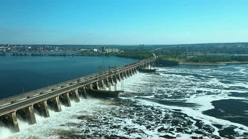 Aerial View of the River Dam, Boiling Water. Cars Go Over the Bridge Over the River Dam. Side View