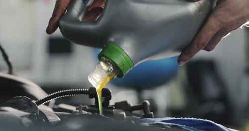 Adding Oil to Car Engine for Maintenance