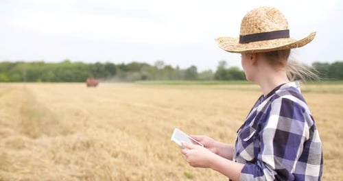 Woman Farmer Using Tablet in Wheat Field