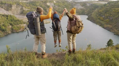Family of Three on Hill Overlooking Lake