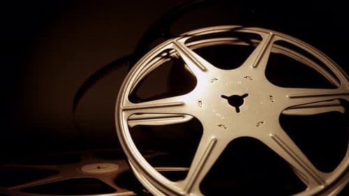 Vintage Film Reel Spinning in Soft Dark Light