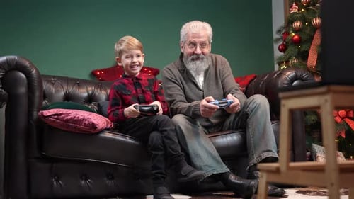 Boy and Grandfather Play Christmas Video Game Together
