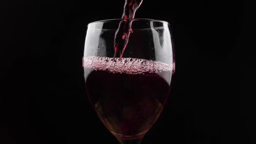 Red Wine Being Poured into Glass