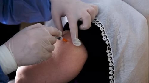 Syringe Injection into Arm in Medical Setting