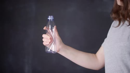 Woman Crushes Plastic Bottle