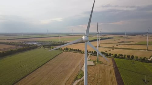 Aerial view of wind turbine generators in field producing clean ecological electricity