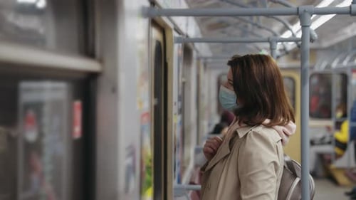 Woman in Mask Commuting in Subway Train