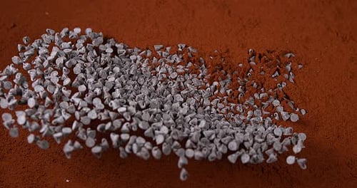 Peppers of Chocolate Falling in Chocolate Powder, Slow Motion 4K