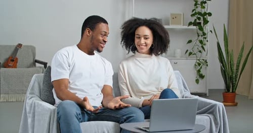 Couple Talking on Laptop Video Call at Home