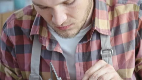 Man Working with Jeweler's Saw Close Up