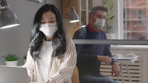 Woman Working on Laptop in Modern Office Space