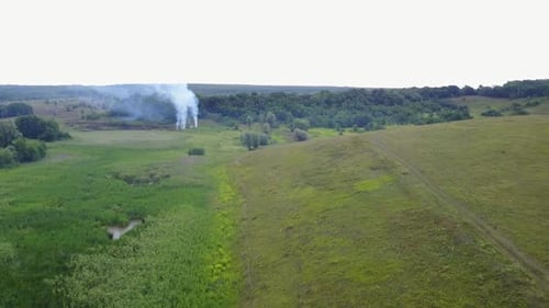 Aerial Footage From Drone of Burning Green Field, Wild Fire in Nature Landscape, Flight Through a