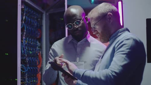 Server Room Technicians Working on Tablet