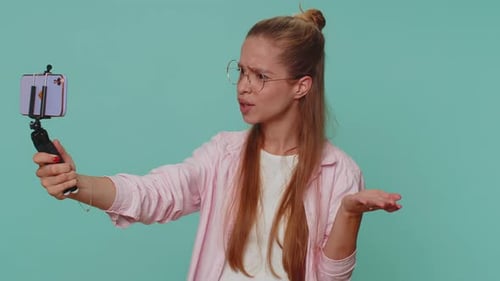 Impressed Girl Blogger Taking Selfie on Mobile Phone Selfie Stick Communicating Video Call Online