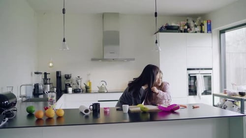 Woman and Child Packing Lunch in Modern Kitchen
