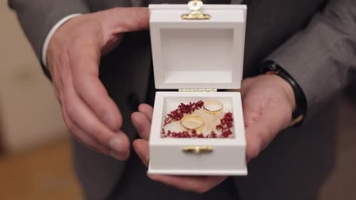 Groom Opens Wedding Ring Box Close Up