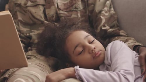 Child Sleeps on Military Parent's Lap