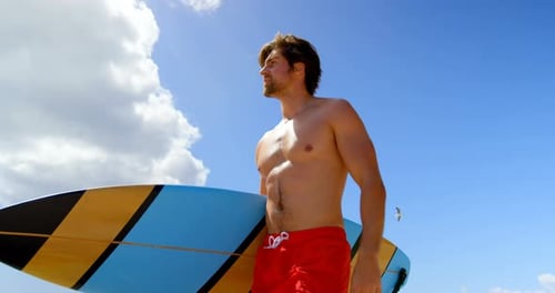 Bottom view of surfer man holding his surfboard 4k
