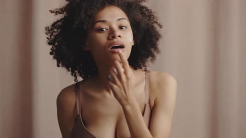 Woman Applies Lotion To Face For Skincare