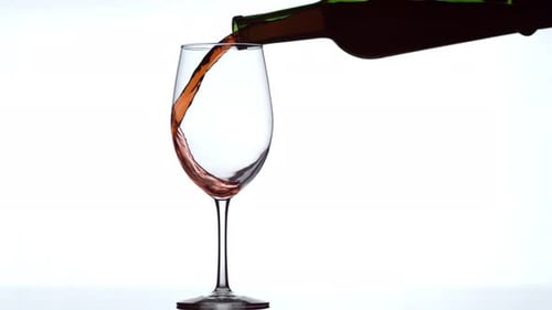 Wine Pouring into Glass on White Background
