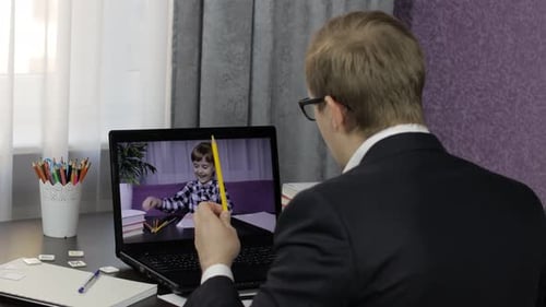 Man and Child Video Call Using Laptop