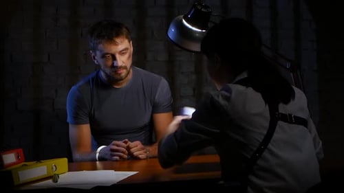 Suspect Under Interrogation by Police Detective at Night