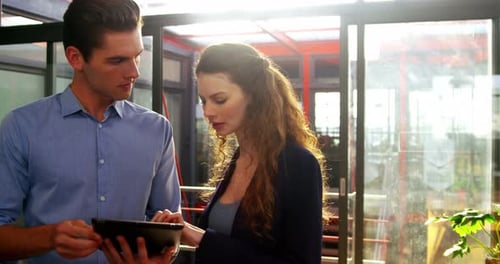 Business Professionals Reviewing Tablet in Bright Office