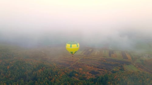 Aerial View on Top Balloon Flight on a Cloudy Foggy Day. Gloomy Winter Day Balloon Blown Away By the