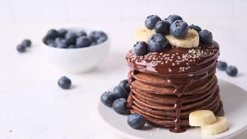 Stacked Chocolate Pancakes with Berries and Banana