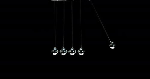 Pendulum, Newton's Cradle, One Ball hits Another against Black Background, Slow Motion 4K