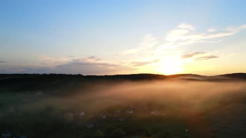 Beautiful Sunset the Sun's Rays Shine Through a Light Fog That Falls on the Evening Village