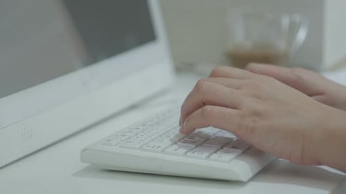 Close Up Typing on Minimalist White Computer Keyboard