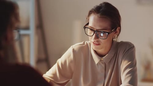 Business Lady Having Discussion with Colleague in Office