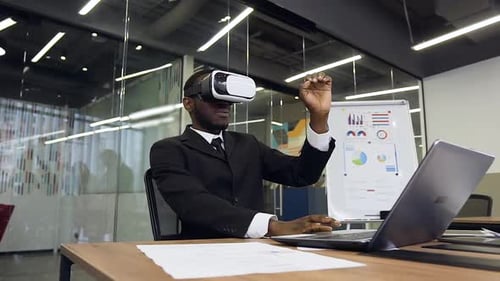 Man Experiencing Virtual Reality at Desk in Office