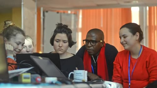 Small Business Team Cooperating in Office with Laptop