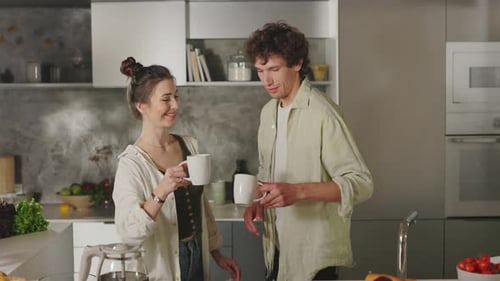 Loving Couple Enjoying Coffee Together in Kitchen