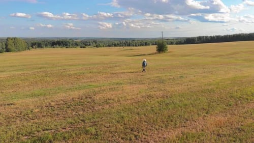 Farmer Walking in Mown Field
