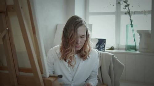 Woman Painting at Easel in Art Studio