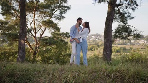A Beautiful Girl and Boy Hugging in a Park