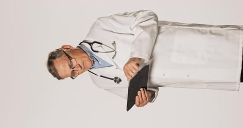 Doctor in White Coat Using Tablet