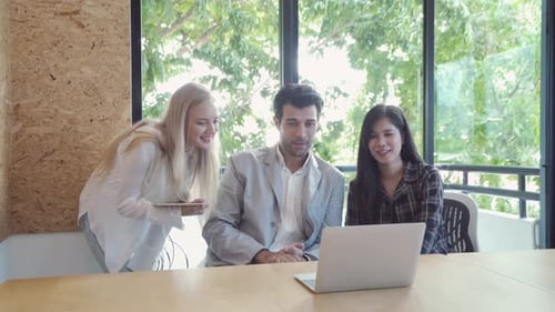 Team Meeting at Modern Workplace with Laptop