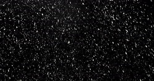 Isolated Snow Falling On The Camera Lens. Slow Motion. Black Background