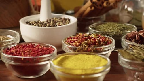 Colorful Spices and Herbs in Bowls on Table