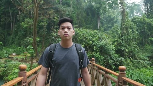 Asian Man Walking On The Wooden Bridge